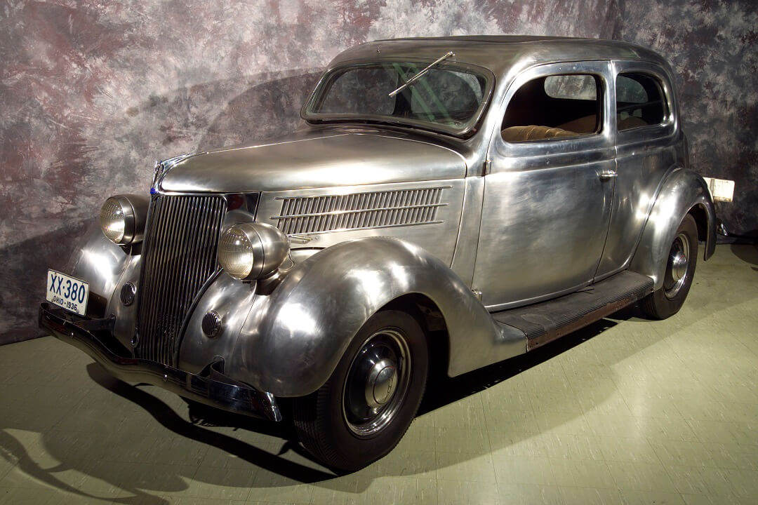 Photo of a stainless steel 1936 Ford Tudor Deluxe Sedan in the Crawford Auto Aviation Museum