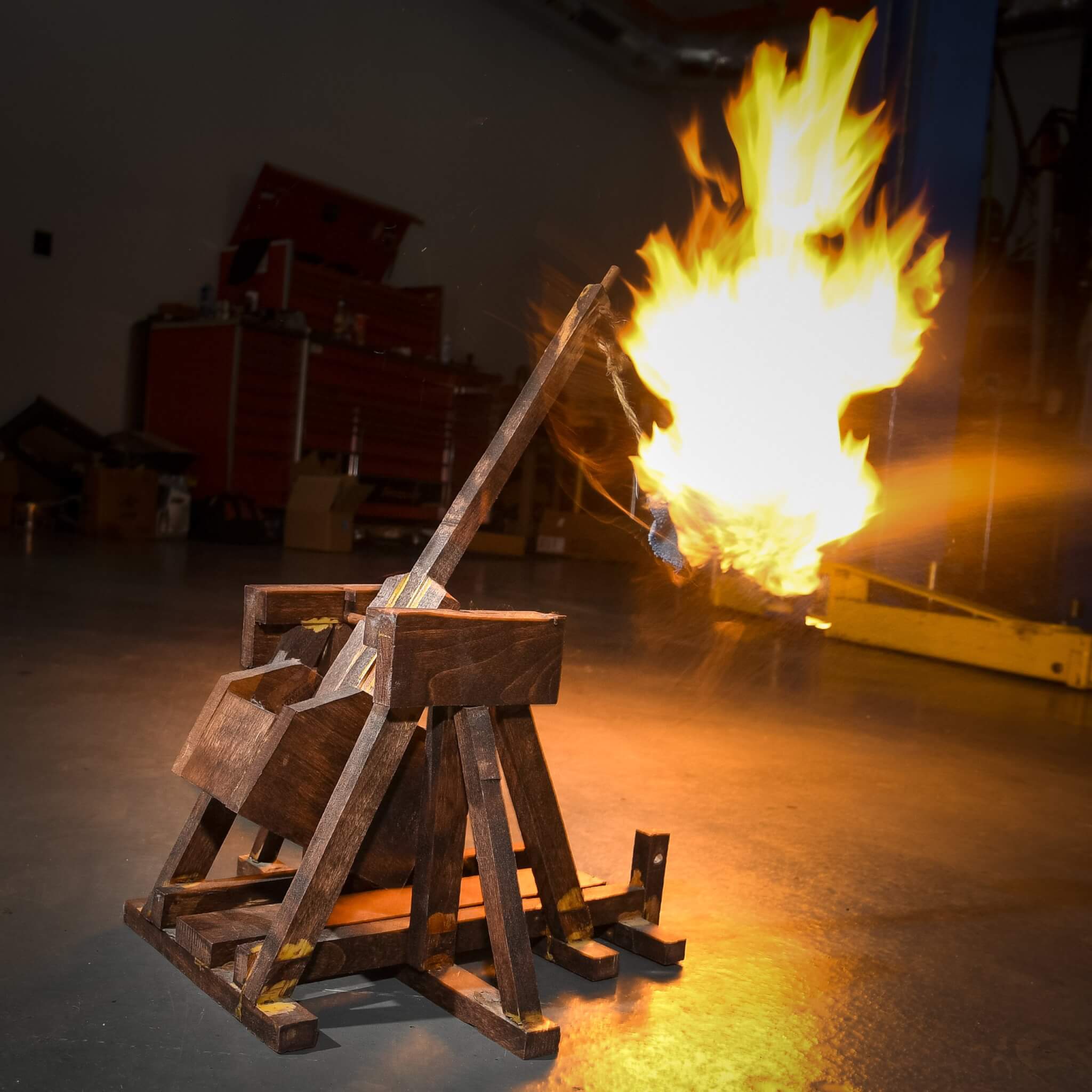 A miniature trebuchet shooting flaming artillery 