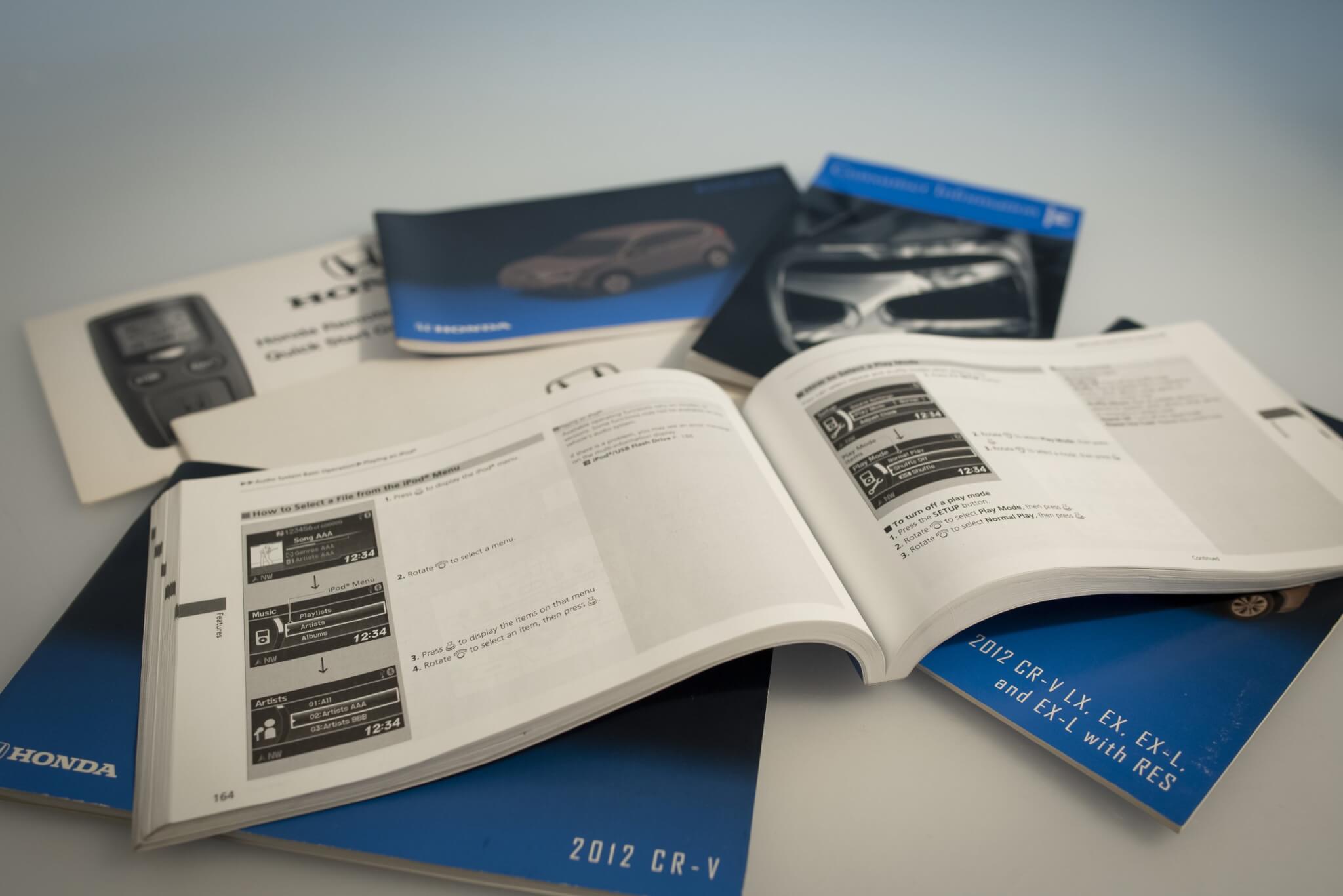 Photo of a Honda CR-V owner's manual and various related booklets