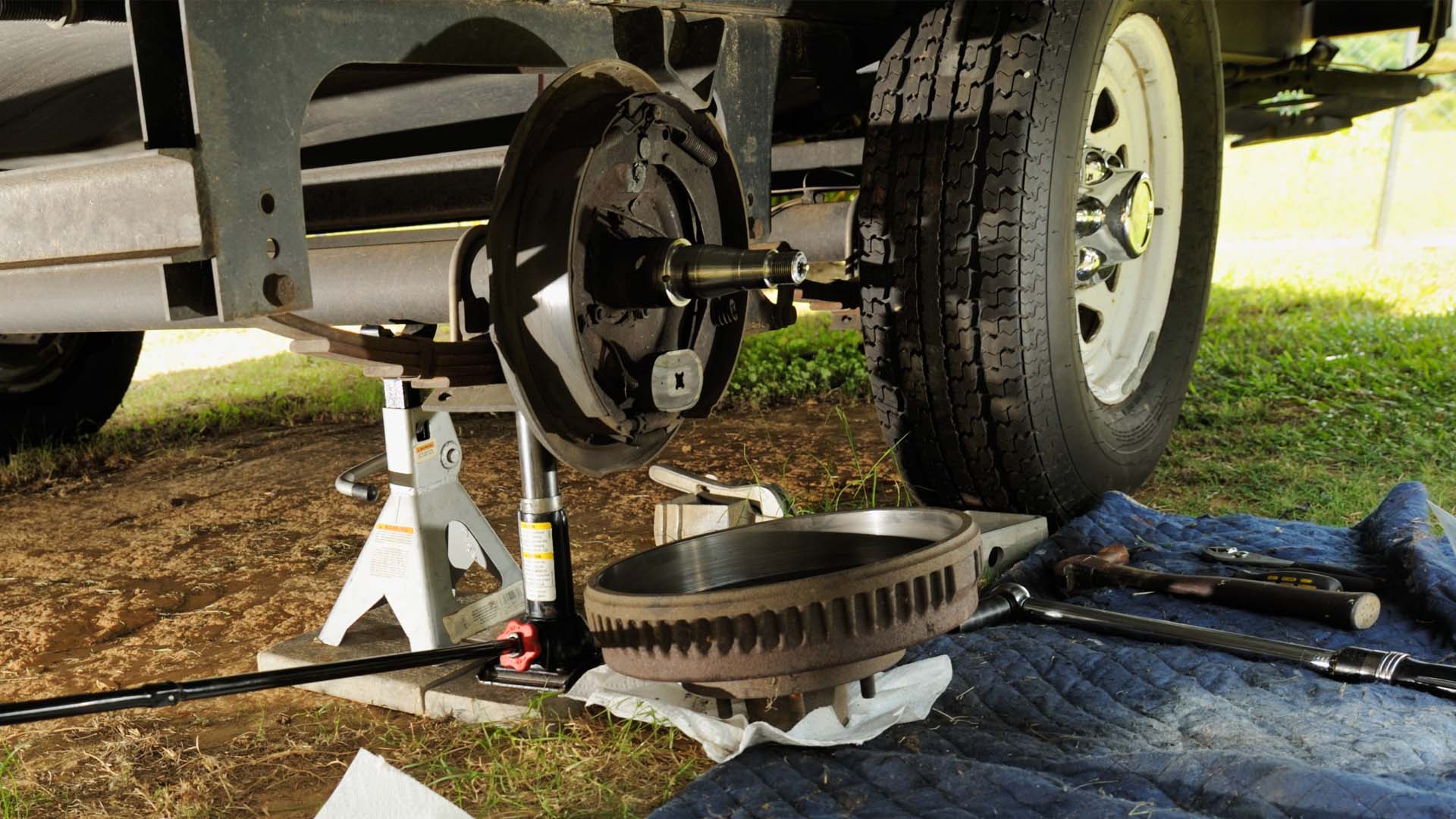 A trailer axle bearing repair occurs outside a shop