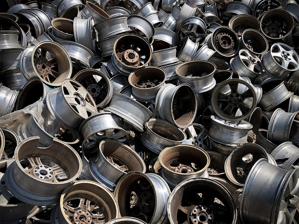 steel wheels in a pile at yard.