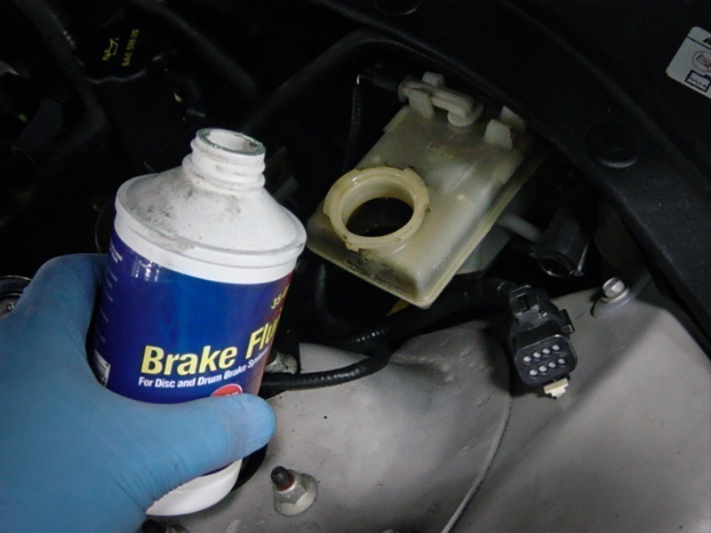 filling up a reservoir with brake fluid