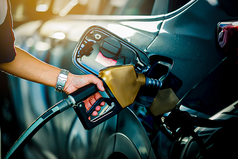 Refilling the car with fuel at the refuel station.