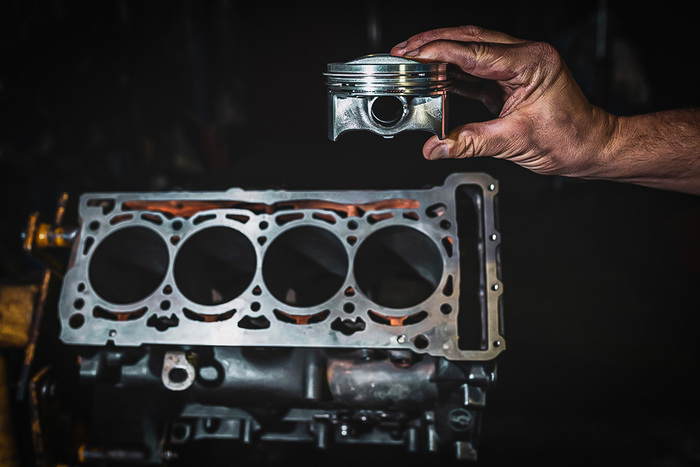 Engine cylinder in the hands of a mechanic
